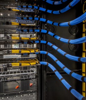 An organized cabling setup within a data center, featuring neatly arranged wires and server racks for efficient management.