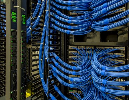 An organized cabling setup within a data center, featuring neatly arranged wires and server racks for efficient management.