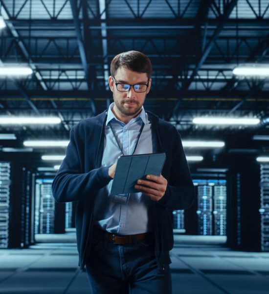 A man doing project management work in a data center.