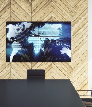 A large digital display in a conference room.