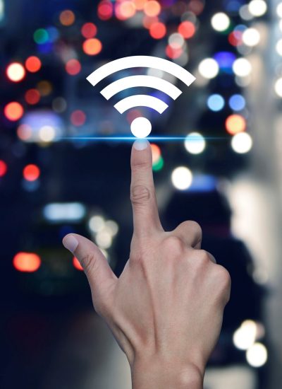 A hand pointing at a wireless signal icon, symbolizing connectivity and modern technology in a digital environment.